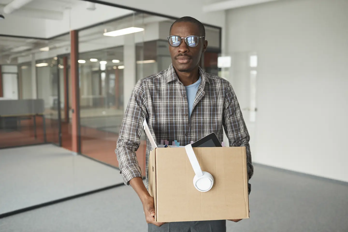 Business-man-storing-items-from-office-in-box.webp